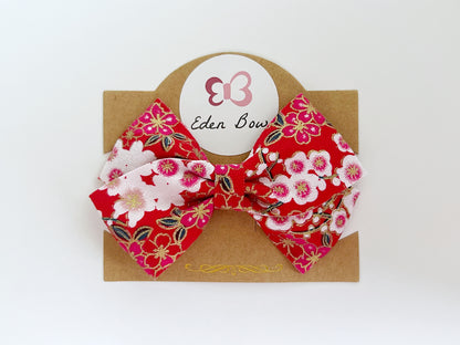 Red sakura flower bow