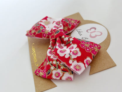 Red sakura flower bow